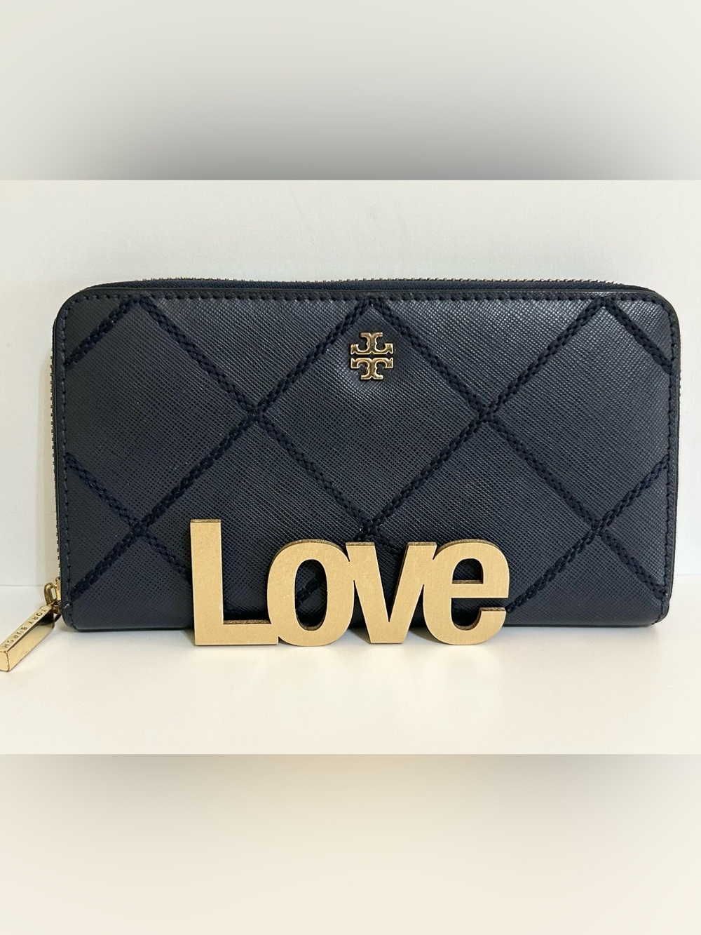 Tory Burch Navy Blue Leather Zip Wallet with Gold Hardware and Diamond Pattern.